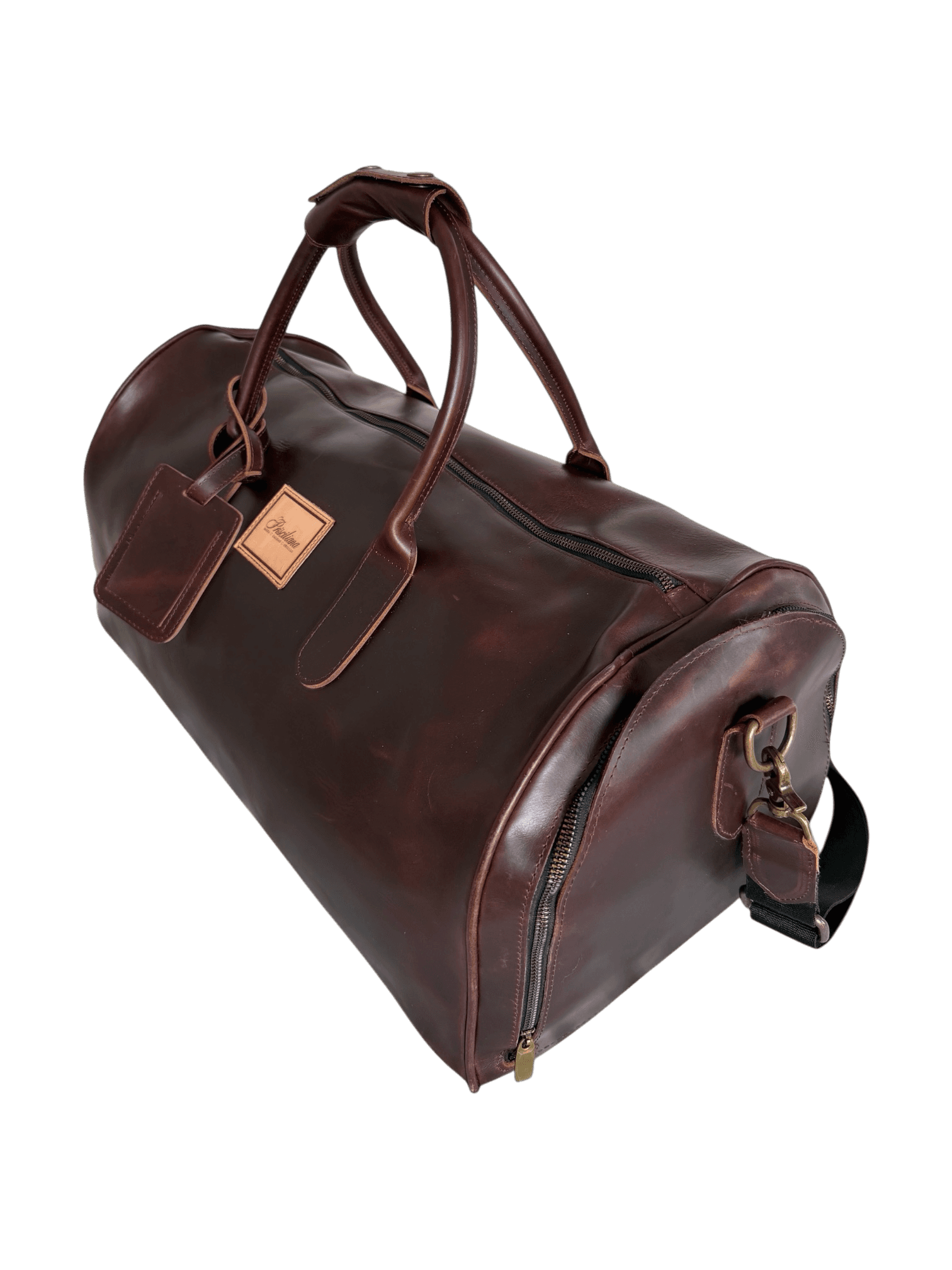 La Herencia Carryall in burgundy leather, angled studio view